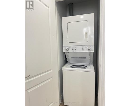 A white washer and dryer in a small space.