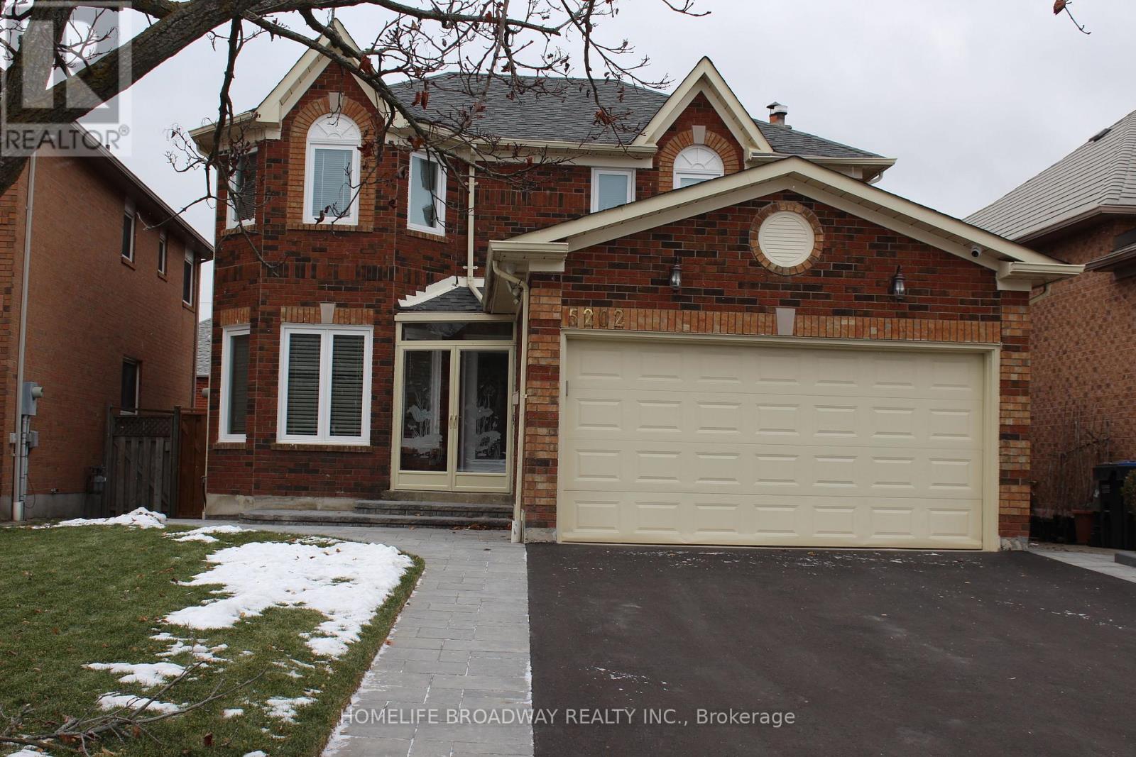 A brick house with a garage door in front.