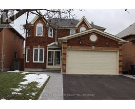 A brick house with a garage door in front.
