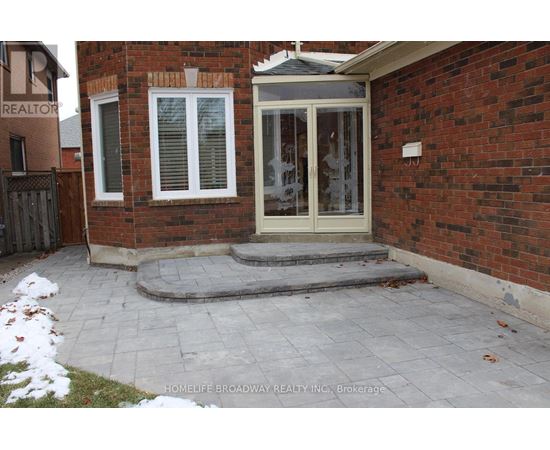A brick house with a glass door and a small porch.