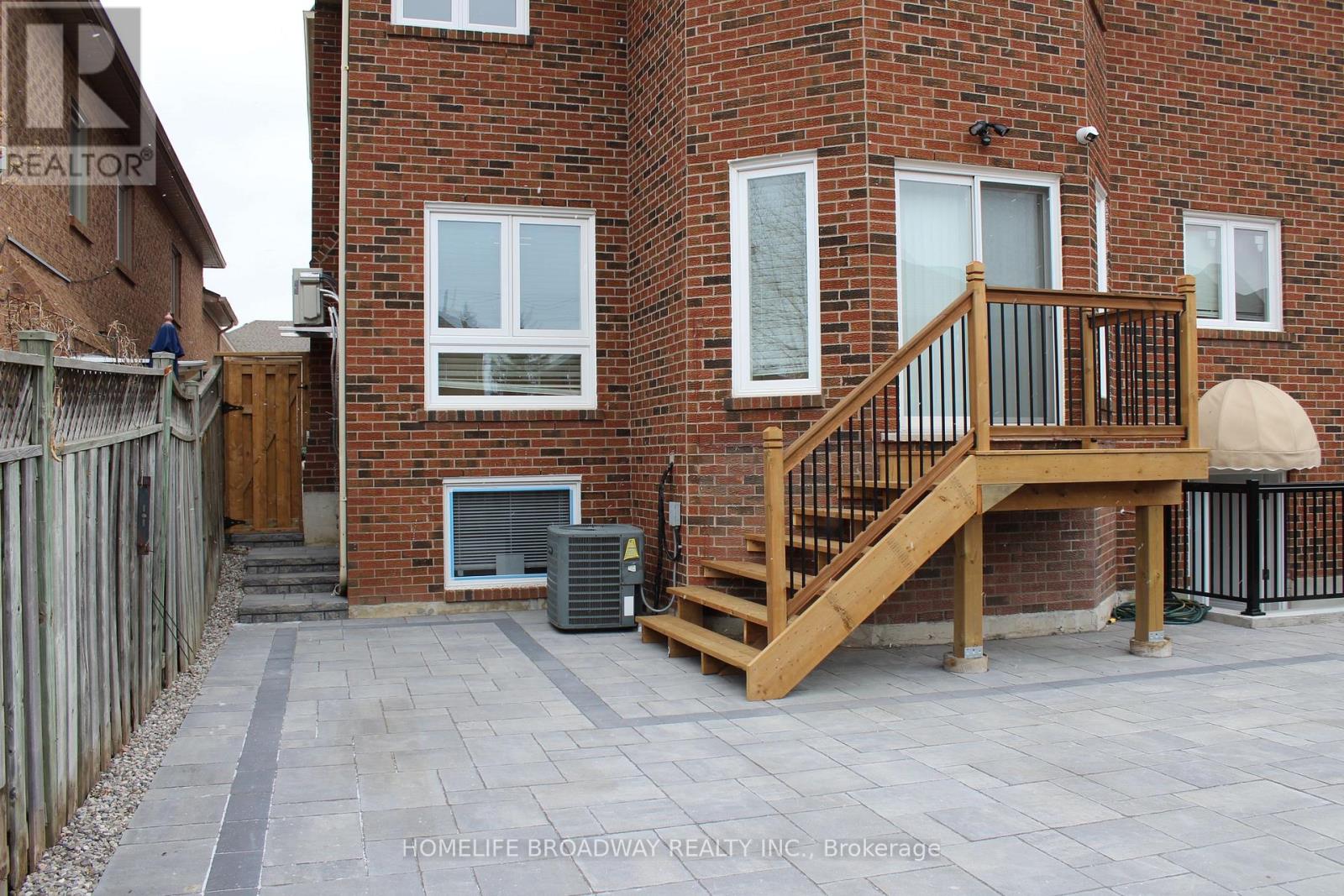 A brick building with a wooden deck in front.