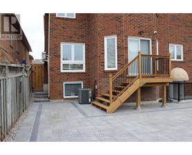 A brick building with a wooden deck in front.