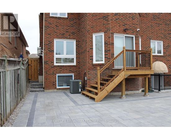A brick building with a wooden deck in front.