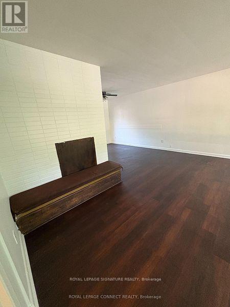 A room with a wooden bench and a white wall.