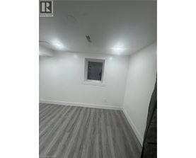 A room with a window and wooden flooring.