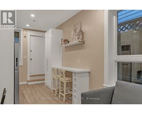 A small kitchen with a table and chairs.
