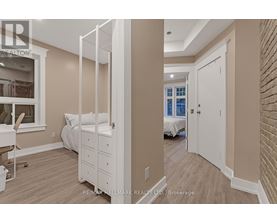 A bedroom with a white bed and a white wardrobe.