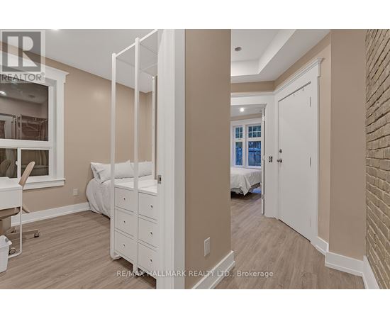 A bedroom with a white bed and a white wardrobe.
