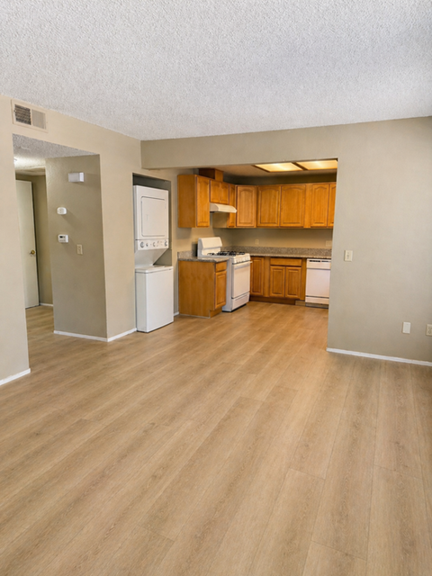 A kitchen with wooden cabinets and white appliances.