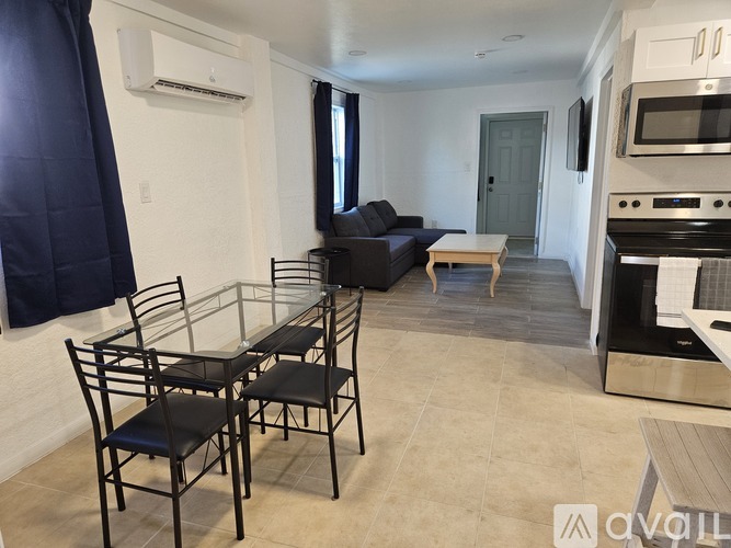 A modern kitchen with a dining table and chairs.