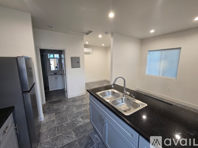 A white bathroom with a sink and a cabinet.