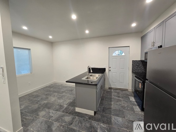 A room with a marble floor and a window on the right side.