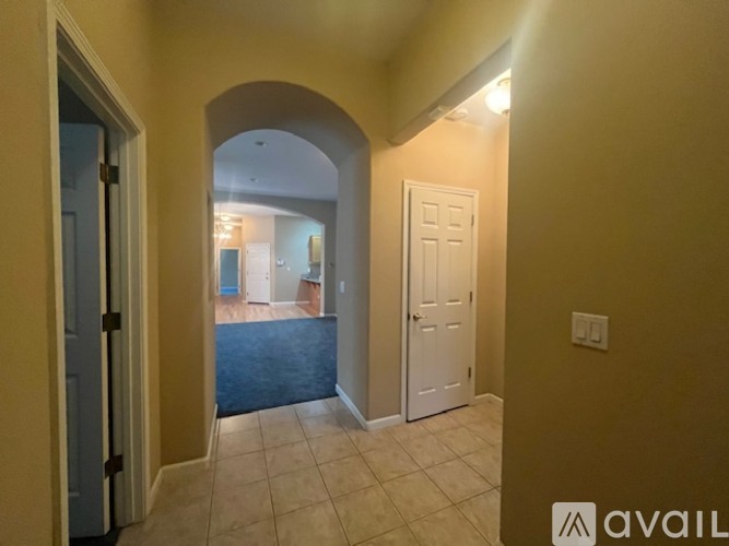 A spacious room with a ceiling fan and large windows.