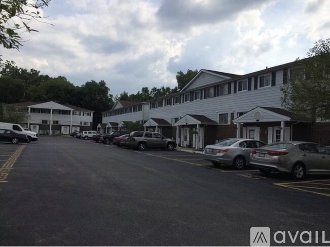 A parking lot with cars and a building in the background.