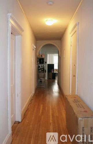 A long hallway with a box on the floor.