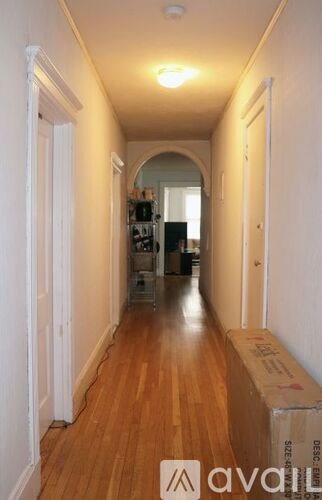A long hallway with a box on the floor.
