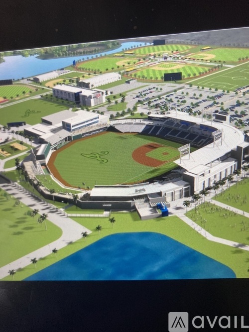 A rendering of a baseball stadium surrounded by buildings and a body of water.