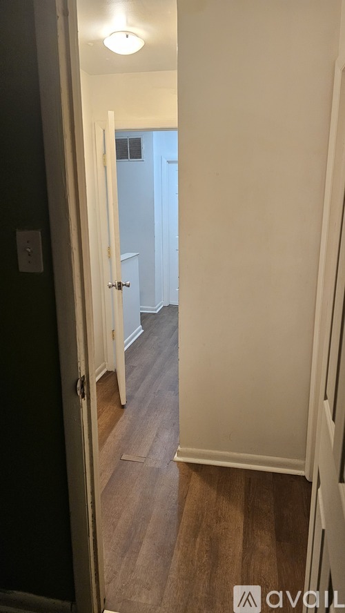 A hallway with a door on the left and a door on the right.