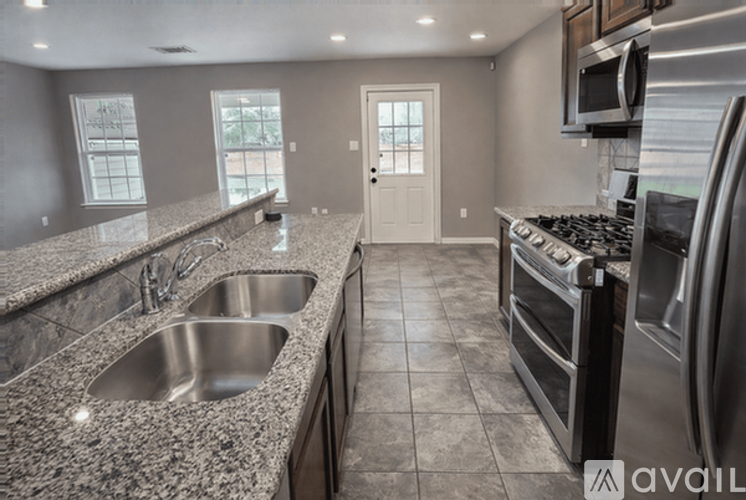 A kitchen with granite countertops and stainless steel appliances is available.