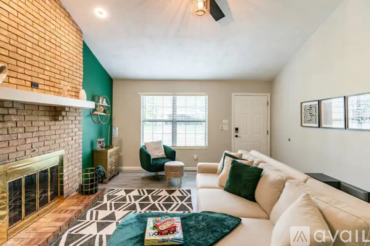 A living room with a fireplace and a white couch.