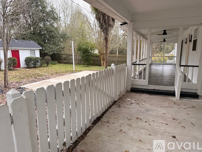 A white picket fence in front of a house.
