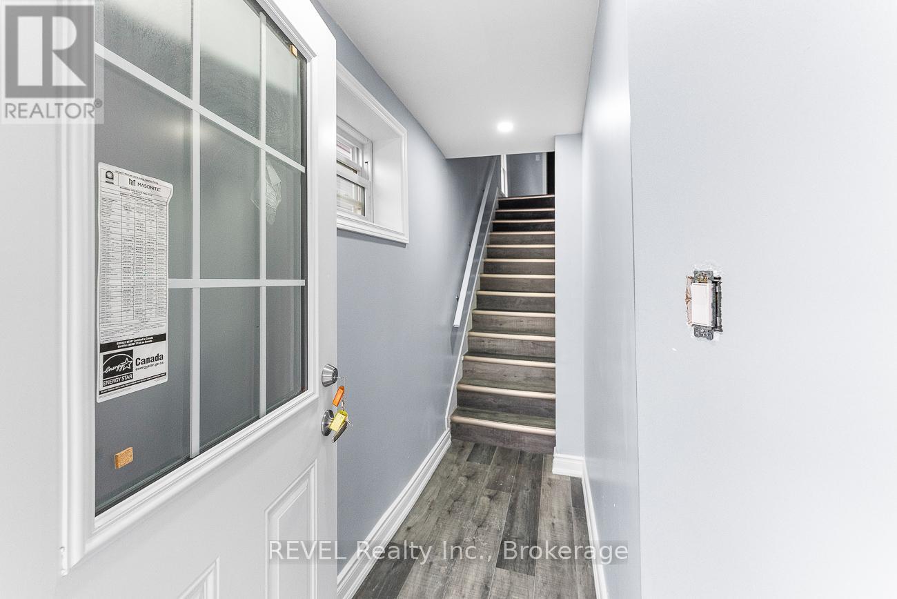 A staircase with a glass door and a sign on it.