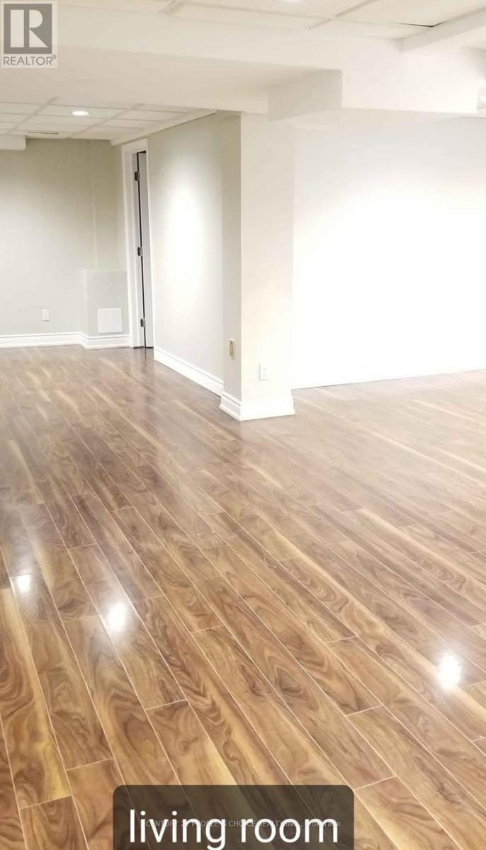A living room with wooden flooring and a sliding door.