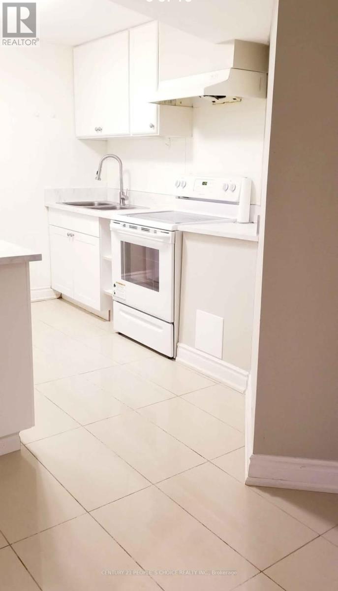 A white kitchen with a sink and oven.