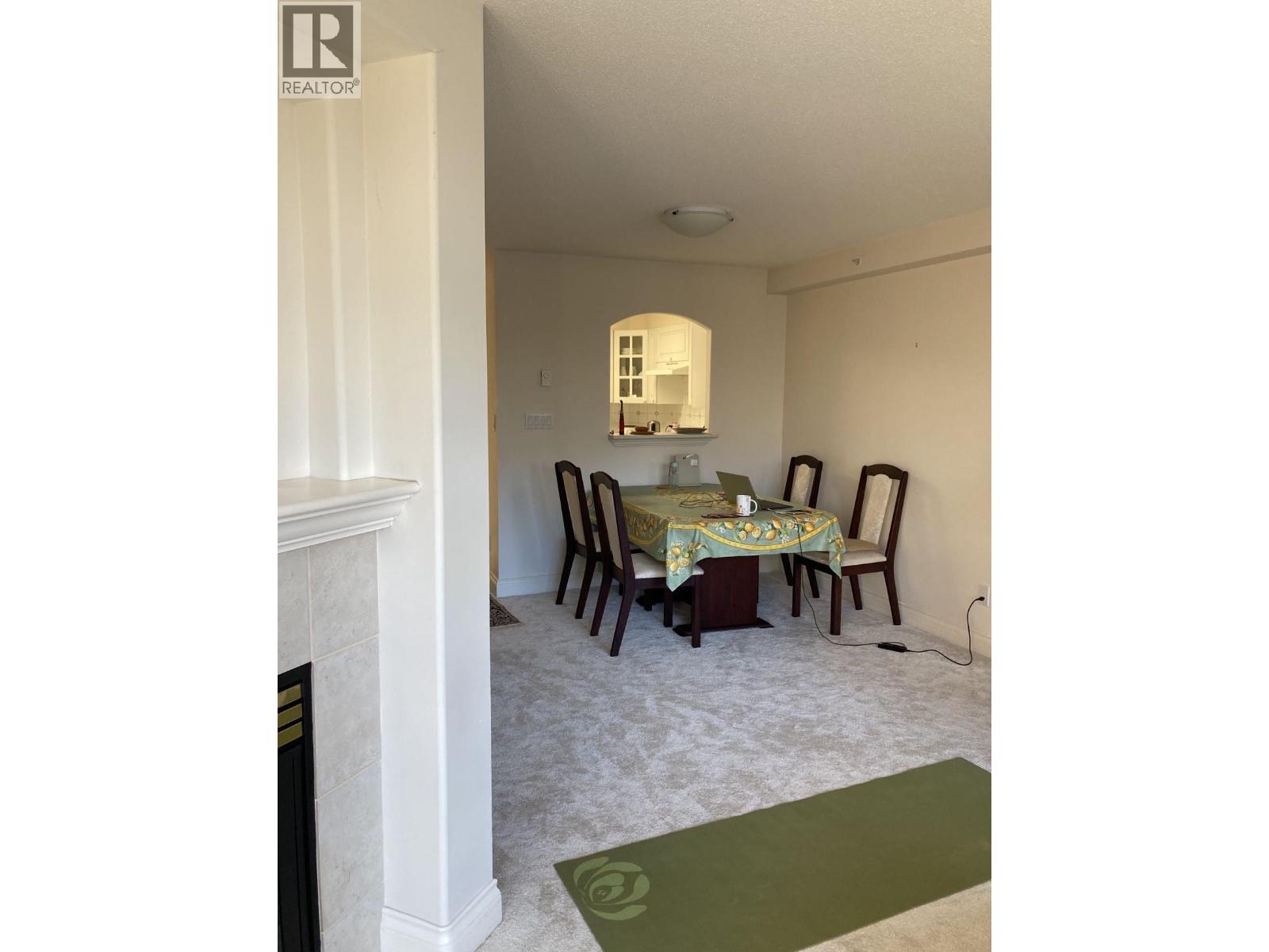 A dining room with a table set for two.