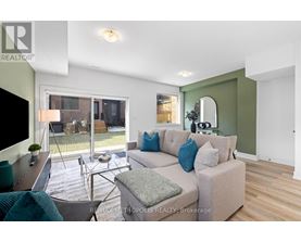 A living room with a couch, a chair, and a television.