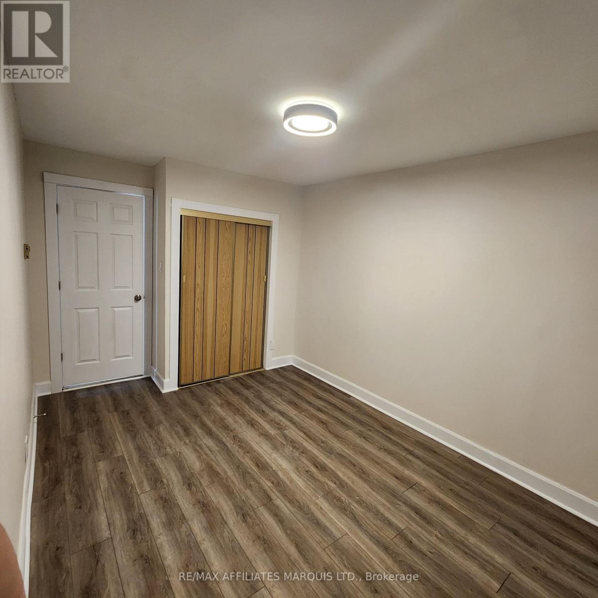 A room with a white door and a wooden door.