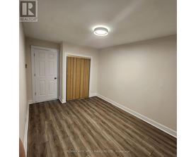 A room with a white door and a wooden door.