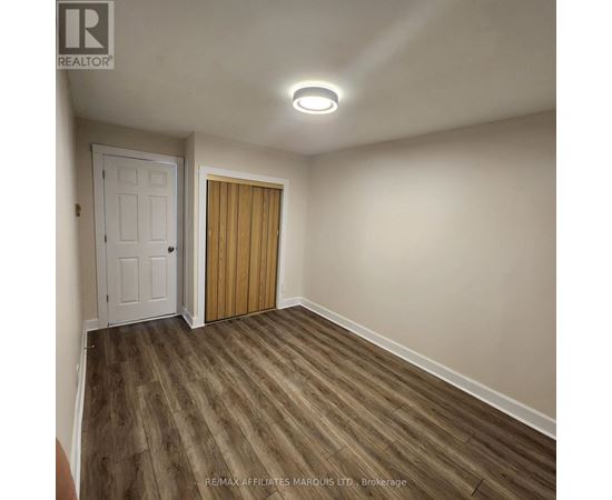 A room with a white door and a wooden door.
