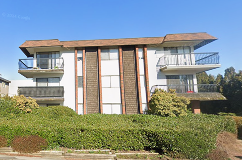 A large two-story building with a balcony on the second floor.