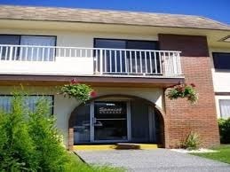 A building with a balcony and a sign that says "Sunshine Coast".