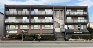 A multi-story building with a sign that reads "Courtyard" on the front.