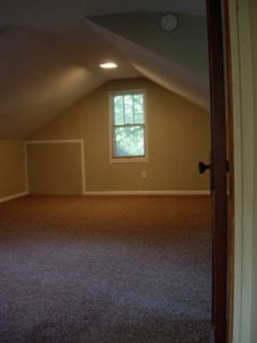 A room with a window and a door.