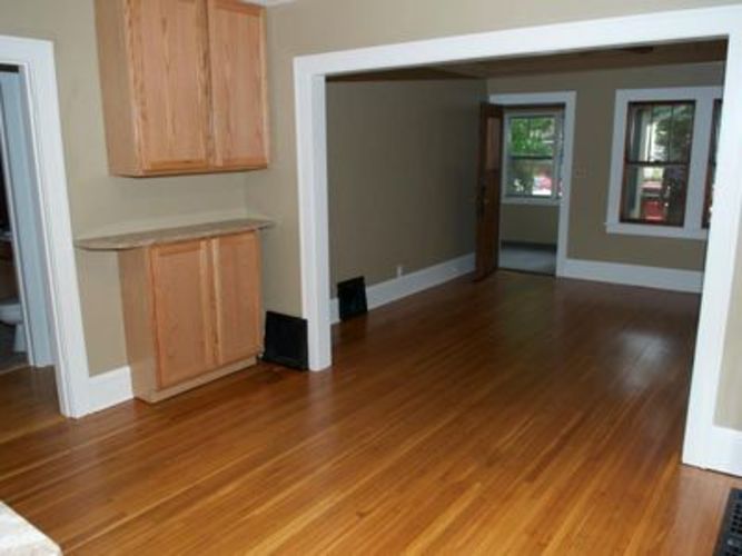A room with wooden floors and a window.