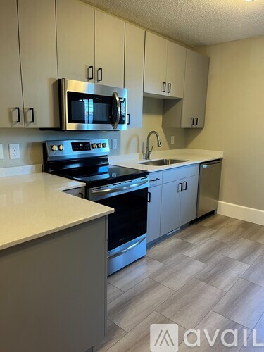 A kitchen with a stove top oven and microwave.