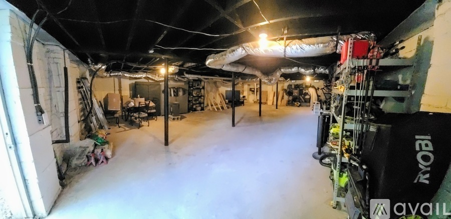 A large, empty warehouse with a lot of white space and some equipment.