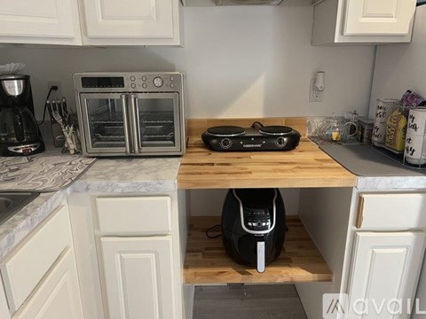 A kitchen with a toaster oven on the counter.