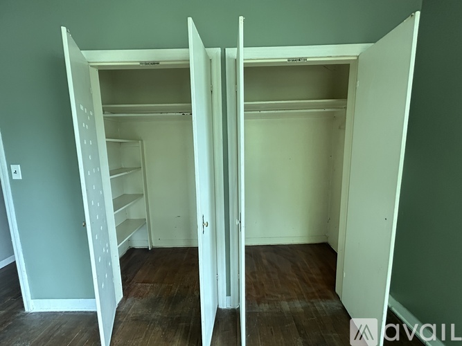 A white closet with shelves and a door open.