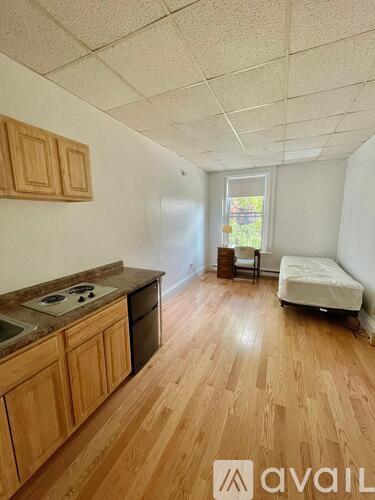 A kitchen with wooden cabinets and a countertop with a sink and stove.