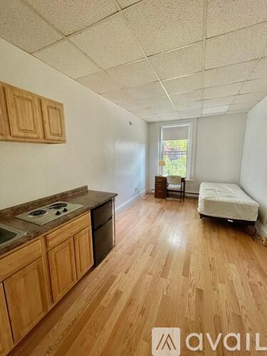 A kitchen with wooden cabinets and a countertop with a sink and stove.
