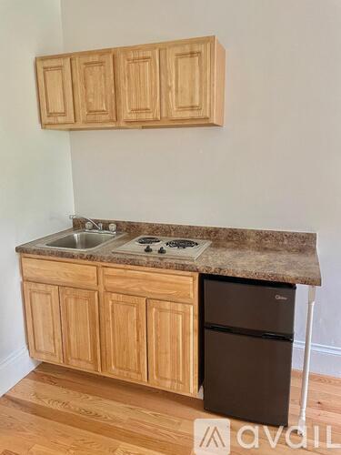 A kitchen with wooden cabinets and a granite countertop.
