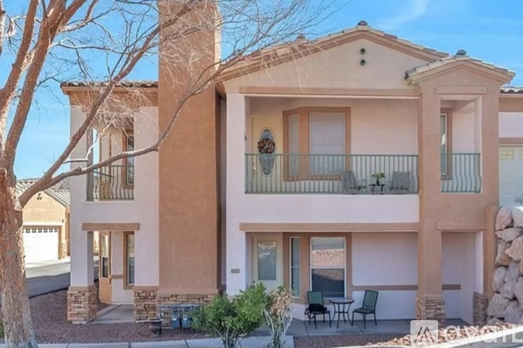 A house with a balcony and a patio table.