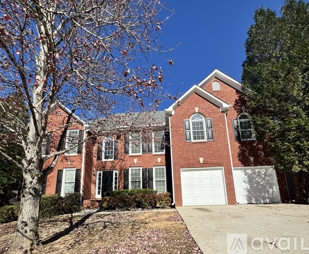 A red brick house with a white garage door.