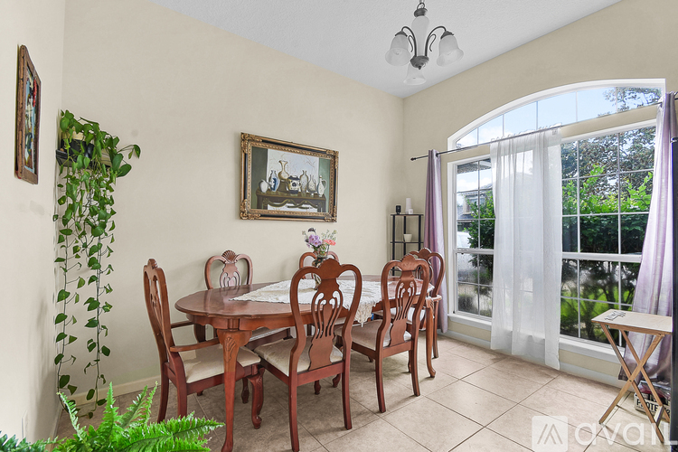 A dining room with a table set for four.