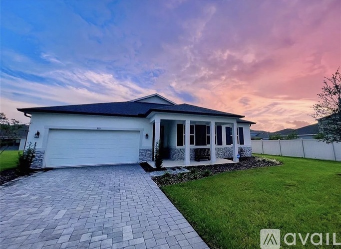 A house with a white garage door is for sale.