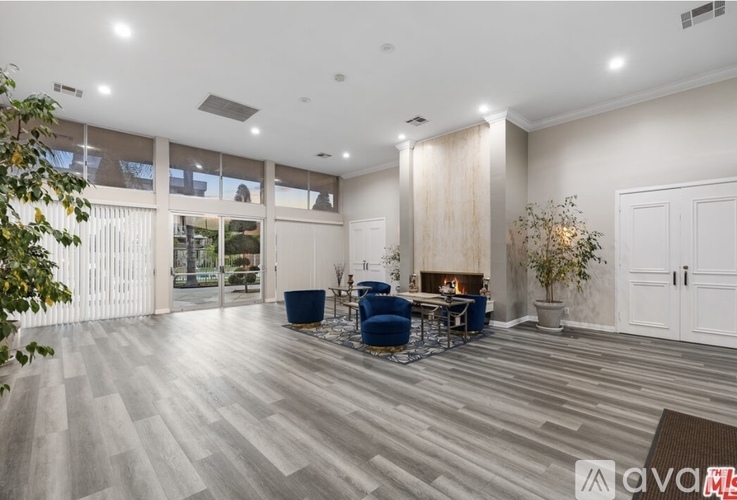 A spacious living room with a fireplace and a dining area.